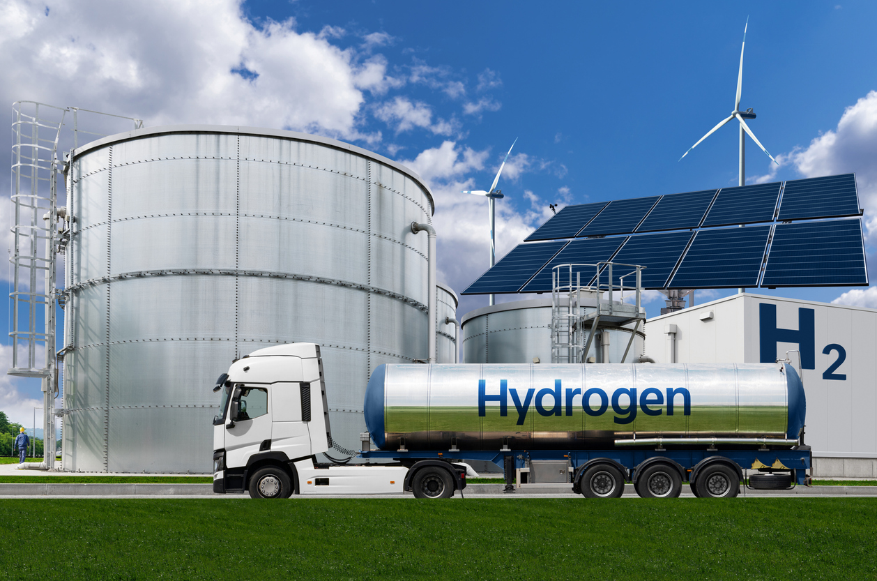Truck with hydrogen tank trailer on the background of gas storage - em360