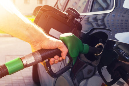 CUM RESIMT ROMÂNII CREȘTEREA PREȚULUI LA PETROL? Refuelling the car at a gas station fuel pump. Man driver hand refilling and pumping gasoline oil the car with fuel at he refuel station. Car refuelling on petrol station. Fuel pump at station - em360