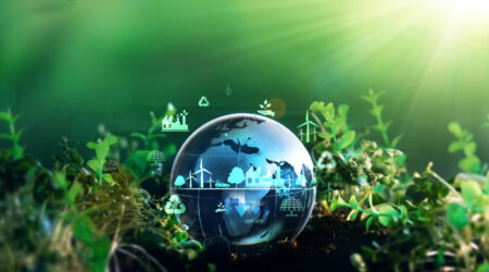 Green energy for clean and sustainable environment. Wind energy used in the industry of factories, machines and technologies. Reducing Co2 emissions and limiting global warming and climate change em360